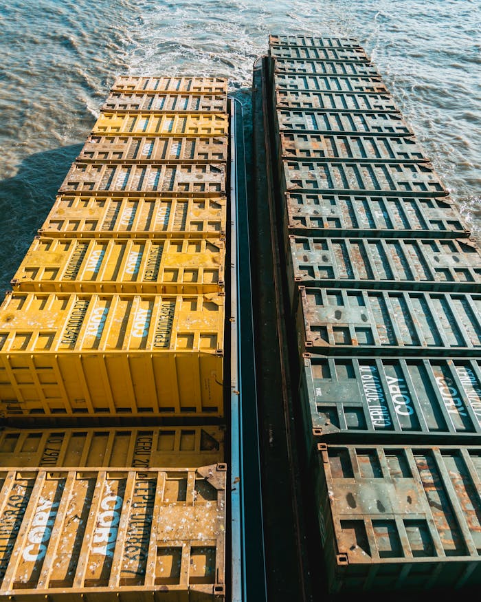 mobile-02 Drone view of colorful cargo containers on a ship navigating through the ocean waters.